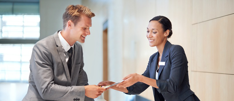 Man and Woman holding and discussing hotel reservation document